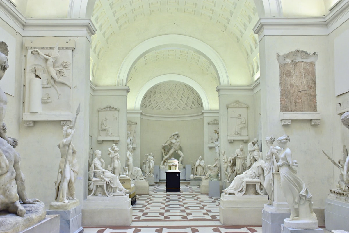 Bright museum gallery with paintings and wooden floor